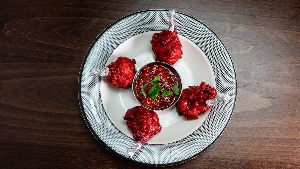 Crispy lollipop chicken served with dipping sauce