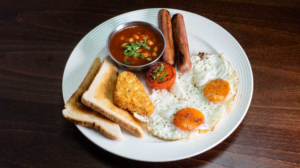 Fried eggs breakfast with sausages and hash brown